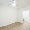 an empty bedroom with wood floors