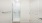 a white bathroom with a glass door